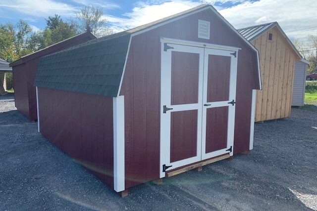 A bright red mini-barn on the Backyard Sheds lot
