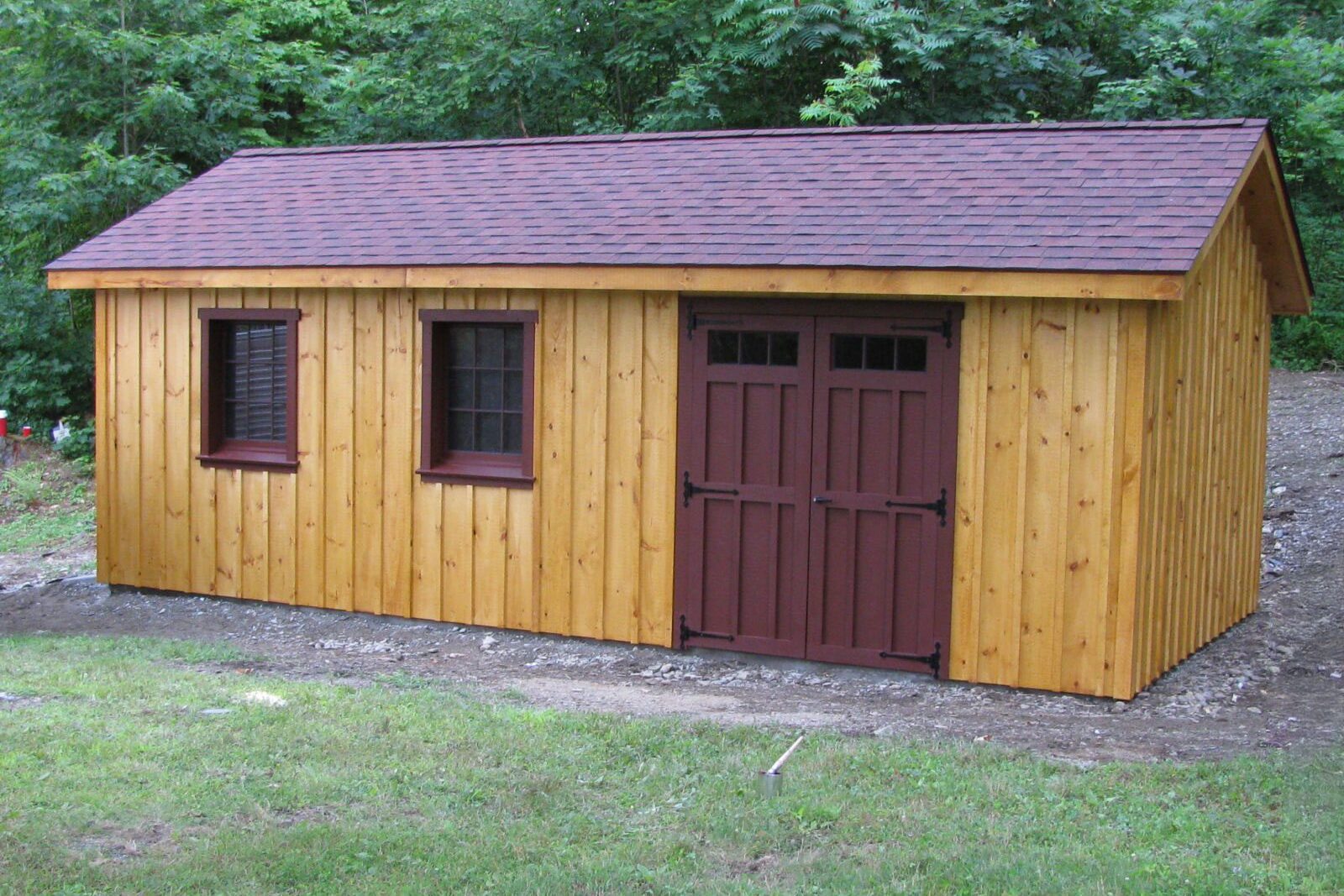 An asymmetric A-Frame with the double-doors off to one side and board-and-batten siding all over.